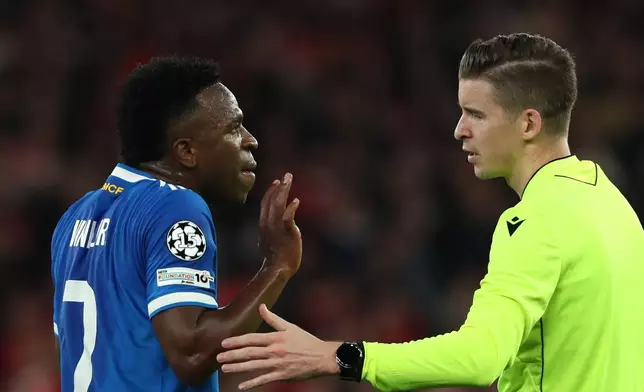 Real Madrid's Vinicius Junior argues with referee François Letexier after scoring the opening goal during a Champions League playoff soccer match between SL Benfica and Real Madrid in Lisbon, Portugal, Tuesday, Feb. 17, 2026. (AP Photo/Pedro Rocha)