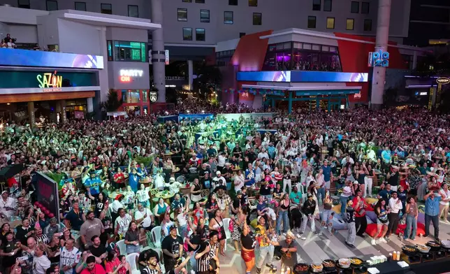 Fans in San Juan, Puerto Rico, watch Bad Bunny's performance on television during the halftime show of the NFL Super Bowl 60 football game Sunday, Feb. 8, 2026. (AP Photo/Alejandro Granadillo)