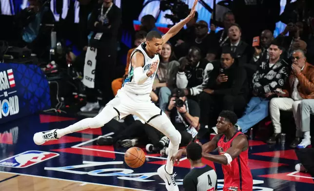 World center Victor Wembanyama, of France, defends on USA Stars guard Anthony Edwards during the NBA All-Star basketball game Sunday, Feb. 15, 2026, in Inglewood, Calif. (AP Photo/Jae C. Hong)