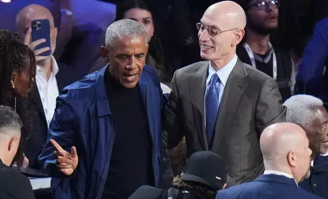 Barack Obama talks to commissioner Adam Silver before the NBA All-Star basketball game Sunday, Feb. 15, 2026, in Inglewood, Calif. (AP Photo/Jae C. Hong)