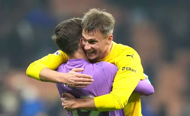 Bodø/Glimt's Odin Bjortuft, right, and goalkeeper Nikita Haikin celebrate after the Champions League soccer match between Inter Milan and Bodø/Glimt, Tuesday, Feb. 24 , 2026, in Milan, Italy (Spada/LaPresse via AP)