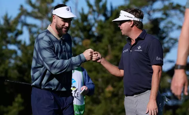Kansas City Chiefs' Travis Kelce, left, fist bumps Keith Mitchell after making a putt on the 10th green at Spyglass Hill Golf Course during the first round of the AT&amp;T Pebble Beach Pro-Am golf tournament in Pebble Beach, Calif., Thursday, Feb. 12, 2026. (AP Photo/Godofredo A. Vásquez)