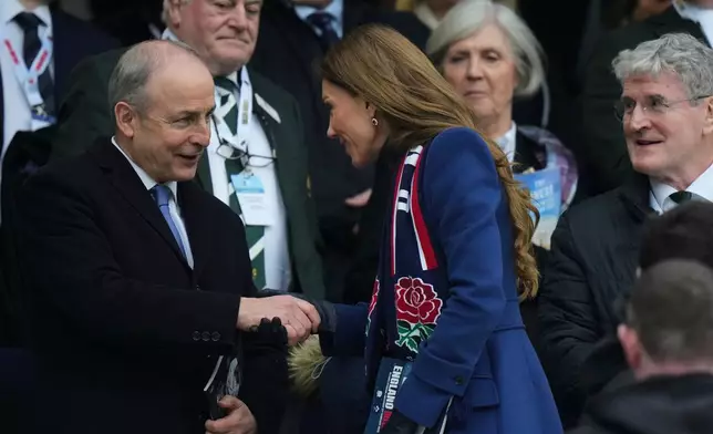 Britain's Kate, Princess of Wales, center, shakes hand with Irish Prime Minister Micheal Martin following the Six Nations rugby union match between England and Ireland in London, England, Saturday, Feb. 21, 2026. (AP Photo/Alastair Grant)