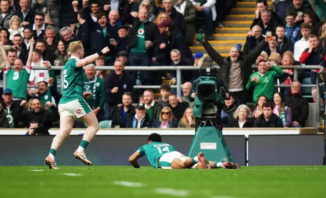 Ireland's Jamie Osborne, left, celebrates as teammate Rob Baloucoune scores a try during the Six Nations rugby union match between England and Ireland in London, England, Saturday, Feb. 21, 2026. (AP Photo/Alastair Grant)