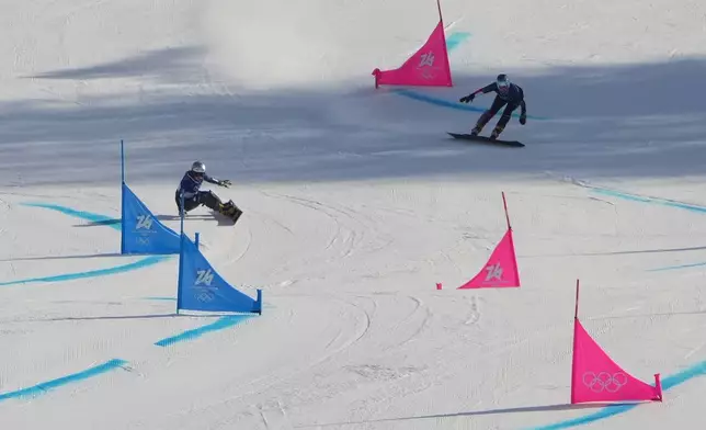 Czechia's Ester Ledecka, left, and Austria's Claudia Riegler compete during the women's snowboarding parallel giant slalom finals at the 2026 Winter Olympics, in Livigno, Italy, Sunday, Feb. 8, 2026. (AP Photo/Lindsey Wasson)