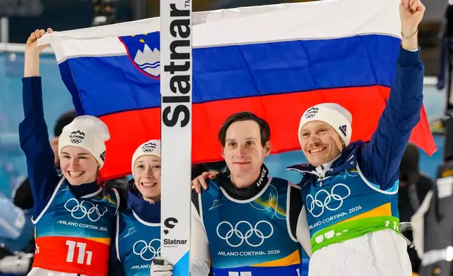 Nika Vodan, from left, Nika Prevc, Domen Prevc, and Anze Lanisek, of Slovenia, pose after winning the gold medal in the ski jumping mixed team competition at the 2026 Winter Olympics, in Predazzo, Italy, Tuesday, Feb. 10, 2026. (AP Photo/Kirsty Wigglesworth)