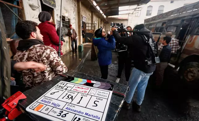 A television crew films an episode of the TV series "Al-Souriyoun al-Aada" ("The Syrian Enemies"), based on a novel of the same name that was banned under Bashar Assad, along a transformed street in central Aleppo, Syria, Friday, Feb. 13, 2026.(AP Photo/Omar Sanadiki)