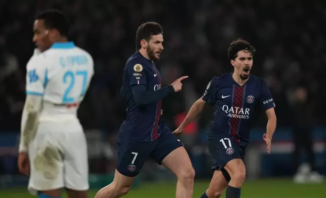 PSG's Khvicha Kvaratskhelia, center, celebrates after scoring his side's fourth goal during the French League One soccer match between Paris Saint-Germain and Marseille in Paris, Sunday, Feb. 8, 2026. (AP Photo/Thibault Camus)