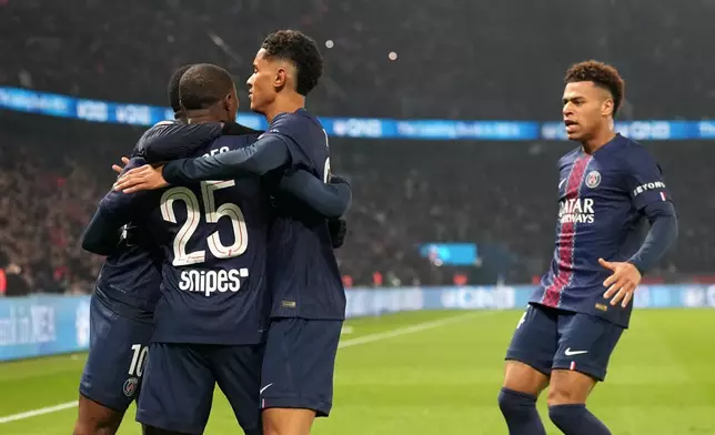 PSG's Ousmane Dembele celebrates with teammates after scoring the opening goal during the French League One soccer match between Paris Saint-Germain and Marseille in Paris, Sunday, Feb. 8, 2026. (AP Photo/Thibault Camus)
