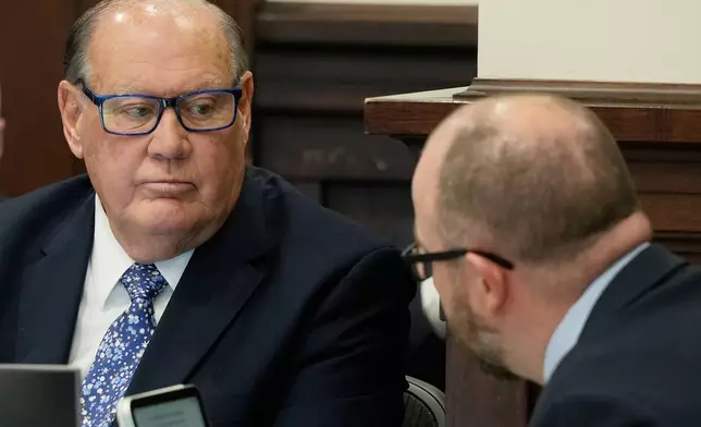 Defendant Chuck Jones, left, listens to Attorney Noah Munyer, right, in Summit County Court of Common Pleas Judge Susan Baker Ross's courtroom on Tuesday, Feb. 3, 2026, in Akron, Ohio. (Mike Cardew/Akron Beacon Journal via AP, Pool)