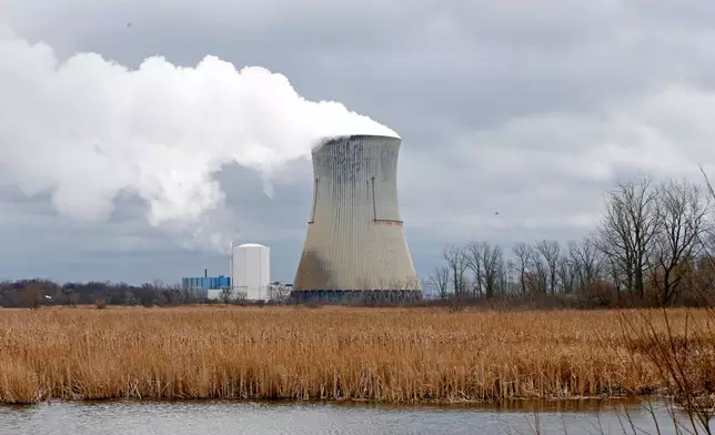 FILE – Plumes of steam drift from the cooling tower of FirstEnergy Corp.'s Davis-Besse Nuclear Power Station in Oak Harbor, Ohio, April 4, 2017. (AP Photo/Ron Schwane, File)