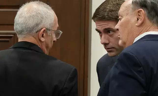 Defendants Michael Dowling, left, and Chuck Jones, right, talk with Attorney Matthew Durkin, center, as they wait for the start of their trial in Summit County Court of Common Pleas Judge Susan Baker Ross's courtroom on Tuesday, Feb. 3, 2026, in Akron, Ohio. (Mike Cardew/Akron Beacon Journal via AP, Pool)