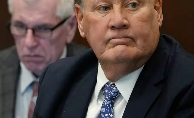Defendant Chuck Jones, a former FirstEnergy Corp. CEO, listens to his attorney Carole Rendon as she gives her opening statement in his and fellow defendant Michael Dowling's trial in Summit County Court of Common Pleas Judge Susan Baker Ross's courtroom, Tuesday, Feb. 3, 2026, in Akron, Ohio. (Mike Cardew/Akron Beacon Journal via AP, Pool)