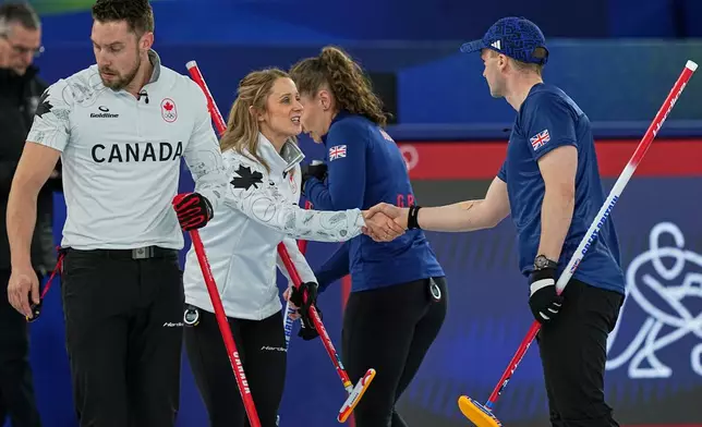 Canada's Jocelyn Peterman shakes hands with Britain's Bruce Mouat during the mixed doubles round robin phase of the curling competition at the 2026 Winter Olympics, in Cortina d'Ampezzo, Italy, Saturday, Feb. 7, 2026. (AP Photo/Fatima Shbair)