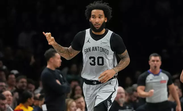 San Antonio Spurs' Julian Champagnie (30) gestures after making a three-point shot during the first half of an NBA basketball game against the Brooklyn Nets Thursday, Feb. 26, 2026, in New York. (AP Photo/Frank Franklin II)