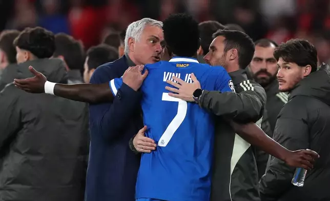 Real Madrid's Vinicius Junior argues with Benfica's head coach José Mourinho after scoring the opening goal during a Champions League playoff soccer match between SL Benfica and Real Madrid in Lisbon, Portugal, Tuesday, Feb. 17, 2026. (AP Photo/Pedro Rocha)