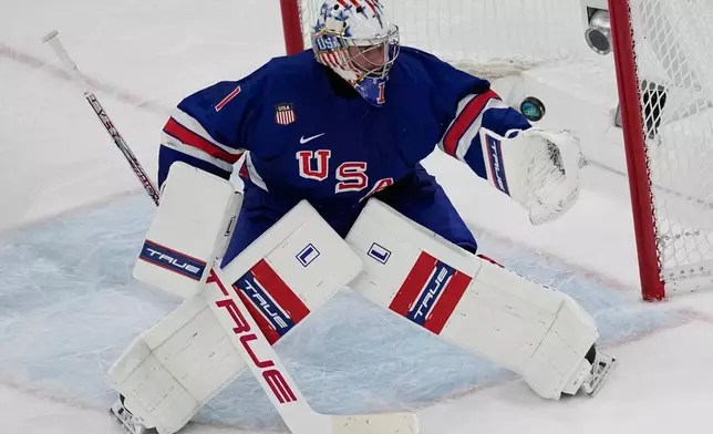 United States' goalkeeper Jeremy Swayman makes a save during a preliminary round match of men's ice hockey between United States and Denmark at the 2026 Winter Olympics, in Milan, Italy, Saturday, Feb. 14, 2026. (AP Photo/Petr David Josek)
