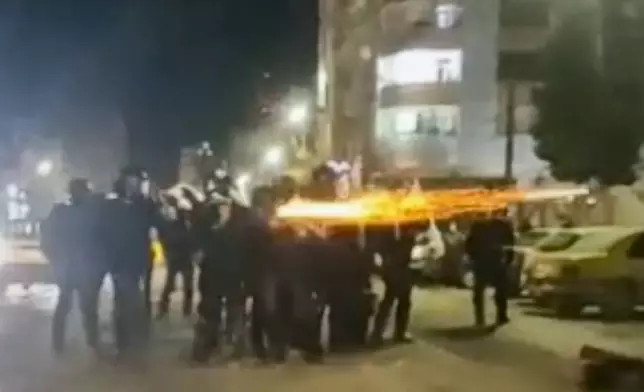 FILE - This image from a video verified by AP shows Iranian security forces shooting into the courtyard outside the Imam Khomeini Hospital, in Ilam, Iran, Jan. 4, 2026. (UGC via AP, File)