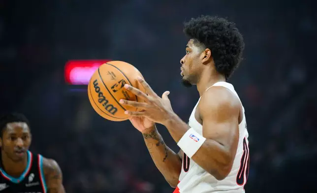 Portland Trail Blazers guard Scoot Henderson, right, looks for an open teammate during the first half of an NBA basketball game against the Memphis Grizzlies, Friday, Feb. 6, 2026, in Portland, Ore. (AP Photo/Molly J. Smith)