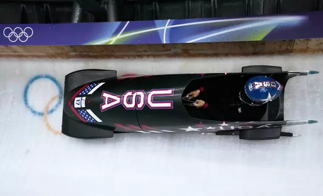 United States' Elana Meyers Taylor slides down the track during a women's monobob training session at the 2026 Winter Olympics, in Cortina d'Ampezzo, Italy, Friday, Feb. 13, 2026. (AP Photo/Aijaz Rahi)