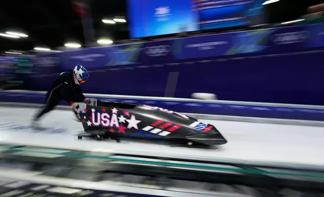 United States' Kaillie Armbruster Humphries starts for a women's monobob training session at the 2026 Winter Olympics, in Cortina d'Ampezzo, Italy, Friday, Feb. 13, 2026. (AP Photo/Alessandra Tarantino)
