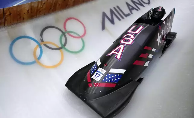 United States' Elana Meyers Taylor slides down the track during a women's monobob training session at the 2026 Winter Olympics, in Cortina d'Ampezzo, Italy, Thursday, Feb. 12, 2026. (AP Photo/Aijaz Rahi)