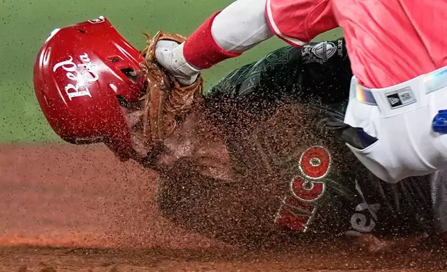 FILE - Mexico Reds catcher Santiago Chavez is tagged out by Puerto Rico's Andrew Velazquez during a Caribbean Series baseball game in Guadalajara, Mexico, Feb. 3, 2026. (AP Photo/Fernando Llano, File)