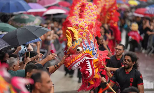 FILE - Dancers perform a dragon dance celebrating the Chinese Lunar New Year in the Asian neighborhood of Liberdade, in Sao Paulo, Jan. 31, 2026, marking the beginning of the Year of the Horse. (AP Photo/Andre Penner, File)