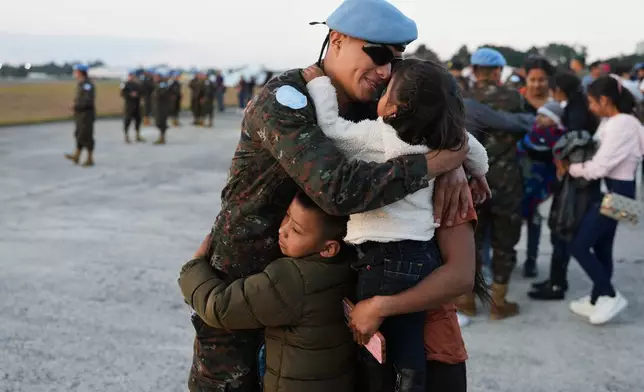 FILE - A soldier embraces his family during a farewell ceremony in Guatemala City, Jan. 31, 2026, before traveling to join the United Nations peacekeeping force in the Democratic Republic of the Congo. (AP Photo/Moises Castillo, File)