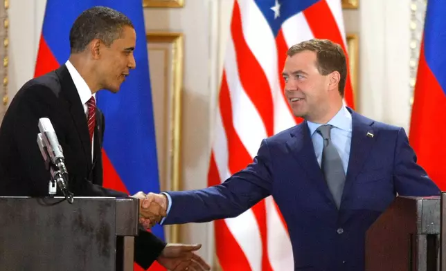 FILE - U.S. President Barack Obama, left, and his Russian counterpart Dmitry Medvedev, right, shake hands at a news conference at the Prague Castle in Prague, Czech Republic,, April 8, 2010, after signing the New START treaty reducing long-range nuclear weapons. (AP Photo/Mikhail Metzel, File)