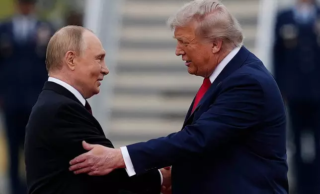 FILE - U.S. President Donald Trump greets Russian President Vladimir Putin, Aug. 15, 2025, at Joint Base Elmendorf-Richardson, Alaska. (AP Photo/Julia Demaree Nikhinson, File)