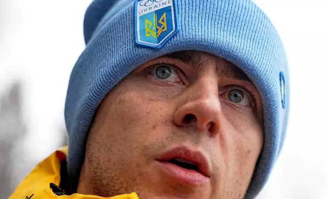 Ukrainian skeleton athlete Vladyslav Heraskevych talks to the media at the start house of the sliding center at the 2026 Winter Olympics, in Cortina d'Ampezzo, Italy, Thursday, Feb. 12, 2026. (AP Photo/Fatima Shbair)