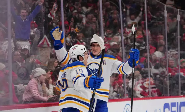 Buffalo Sabres' Peyton Krebs, left, celebrates with Tage Thompson after Krebs scored a goal during the third period of an NHL hockey game against the New Jersey Devils Wednesday, Feb. 25, 2026, in Newark, N.J. (AP Photo/Frank Franklin II)