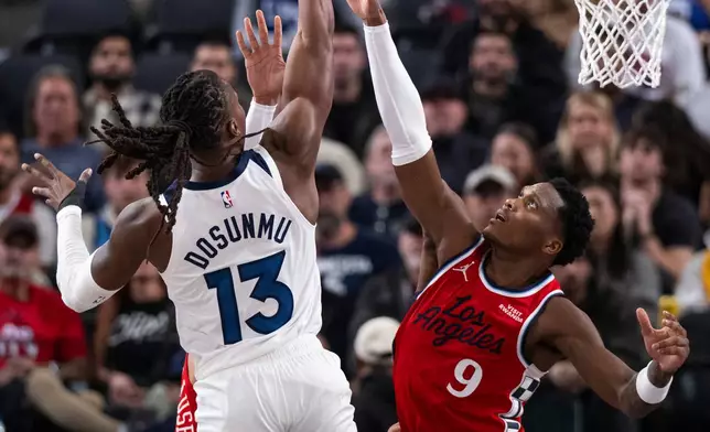Minnesota Timberwolves guard Ayo Dosunmu (13) shoots over Los Angeles Clippers guard Bennedict Mathurin (9) during the first half of an NBA basketball game Thursday, Feb. 26, 2026, in Inglewood, Calif. (AP Photo/Kyusung Gong)