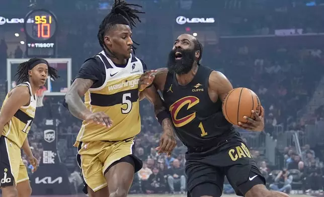 Cleveland Cavaliers guard James Harden (1) drives against Washington Wizards guard Jamir Watkins (5) in the first half of an NBA basketball game in Cleveland, Wednesday, Feb. 11, 2026. (AP Photo/Sue Ogrocki)