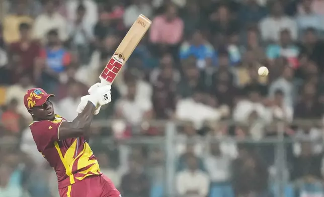 West Indies' Rovman Powell plays a shot during the T20 World Cup cricket match between Zimbabwe and West Indies in Mumbai, India, Monday, Feb. 23, 2026. (AP Photo/Rafiq Maqbool)