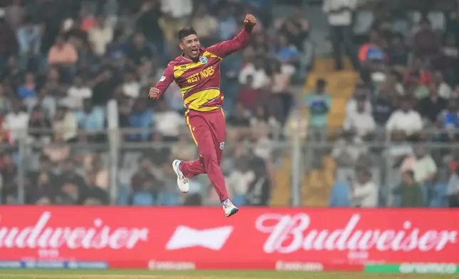 West Indies' Gudakesh Motie celebrates the wicket of Zimbabwe's Tashinga Musekiwa during the T20 World Cup cricket match between Zimbabwe and West Indies in Mumbai, India, Monday, Feb. 23, 2026. (AP Photo/Rafiq Maqbool)