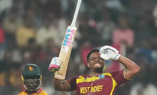 West Indies' Shimron Hetmyer celebrates his fifty runs during the T20 World Cup cricket match between Zimbabwe and West Indies in Mumbai, India, Monday, Feb. 23, 2026. (AP Photo/Rafiq Maqbool)