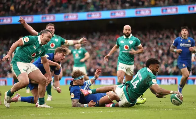 Ireland's Robert Baloucoune, goes over the line to score a try during a Six Nations rugby union match between Ireland and Italy in Dublin, Ireland, Saturday, Feb. 14, 2026. (AP Photo/Peter Morrison)