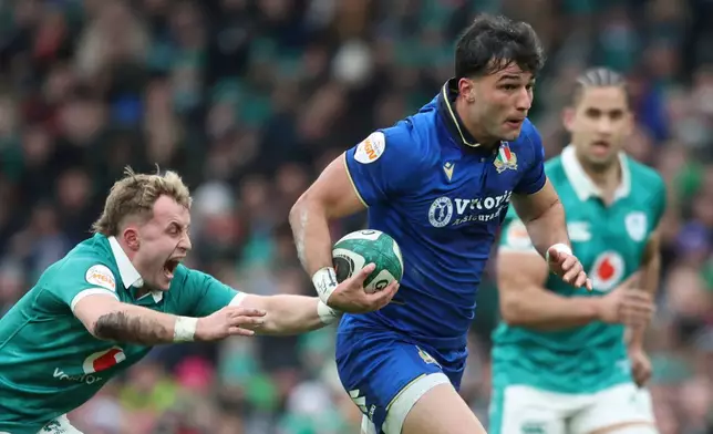 Italy's Lorenzo Pani, right, is tackled by Ireland's Craig Casey, during a Six Nations rugby union match between Ireland and Italy in Dublin, Ireland, Saturday, Feb. 14, 2026. (AP Photo/Peter Morrison)