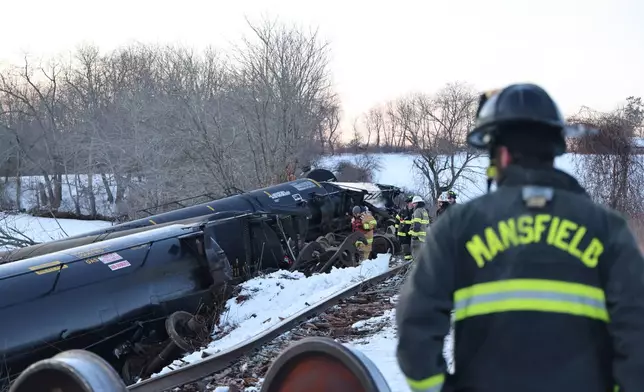This photo provided by the Connecticut Division of Emergency Management and Homeland Security shows firefighters responding to a freight train derailment, in Mansfield, Conn., Thursday, Feb. 5, 2026. (Alexis Paquette/Connecticut Division of Emergency Management and Homeland Security via AP)