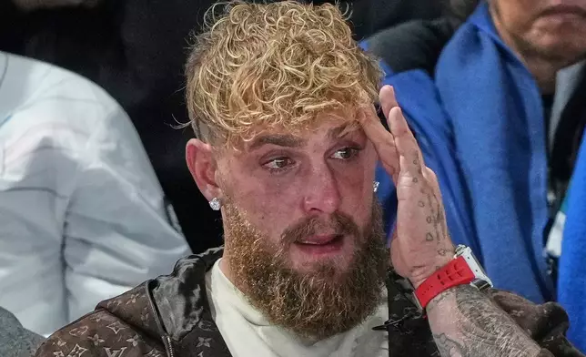 Jake Paul of the U.S. cries after his finale Jutta Leerdam of the Netherlands won the gold medal in the women's 1,000 meters speedskating race at the 2026 Winter Olympics, in Milan, Italy, Monday, Feb. 9, 2026. (AP Photo/Antonio Calanni)