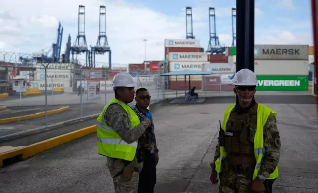Workers stand at the entrance of the Balboa terminal, run by CK Hutchison's Panama Ports Co., after Panama government ordered the occupation of the port following a Supreme Court ruling that the concession was unconstitutional inPanama City, Panama, Monday, Feb. 23, 2026. (AP Photo/Matias Delacroix)