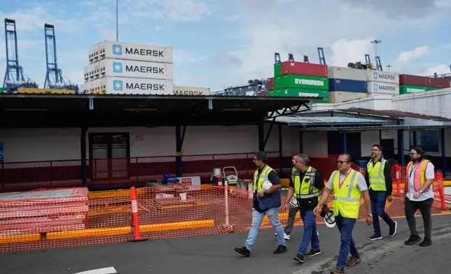 Workers walk at the Balboa terminal, run by CK Hutchison's Panama Ports Co., after Panama government ordered the occupation of the port following a Supreme Court ruling that the concession was unconstitutional inPanama City, Panama, Monday, Feb. 23, 2026. (AP Photo/Matias Delacroix)