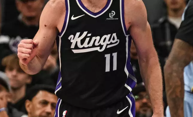 Sacramento Kings forward Domantas Sabonis reacts after a basket during the first half of an NBA basketball game against the Memphis Grizzlies, Wednesday, Feb. 4, 2026, in Sacramento, Calif. (AP Photo/Justine Willard)