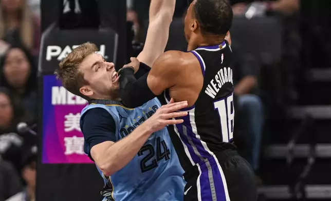 Sacramento Kings guard Russell Westbrook (18) shoots over Memphis Grizzlies guard Cam Spencer (24) during the first half of an NBA basketball game, Wednesday, Feb. 4, 2026, in Sacramento, Calif. (AP Photo/Justine Willard)