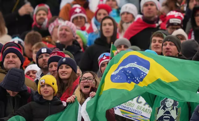 Brazilian fans cheer during the medal ceremony of an alpine ski, men's giant slalom race, won by Brazil's Lucas Pinheiro Braathen, at the 2026 Winter Olympics, in Bormio, Italy, Saturday, Feb. 14, 2026. (AP Photo/Julia Demaree Nikhinson)