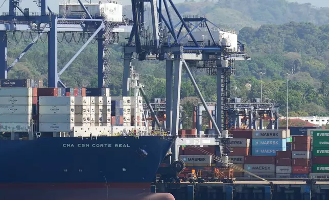 Cranes load a cargo ship at Panama Canal's Port of Balboa, managed by CK Hutchison Holdings, in Panama City, Friday, Jan. 30, 2026. (AP Photo/Matias Delacroix)