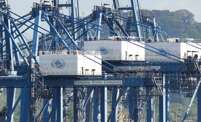Cranes load a cargo ship at Panama Canal's Port of Balboa, managed by CK Hutchison Holdings, in Panama City, Friday, Jan. 30, 2026. (AP Photo/Matias Delacroix)