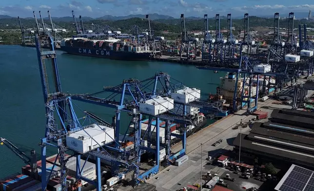 Cranes load a cargo ship at Panama Canal's Port of Balboa, managed by CK Hutchison Holdings, in Panama City, Friday, Jan. 30, 2026. (AP Photo/Matias Delacroix)